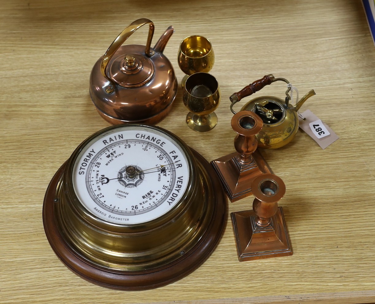 A Gamages aneroid barometer and a group of metalware, barometer 36 cms diameter including wooden base